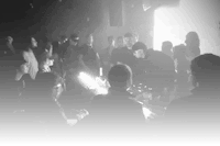 a black and white photo of a crowd at a club